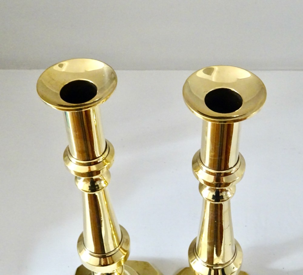 A pair of polished brass turned candlesticks featuring square bases and baluster columns. View III