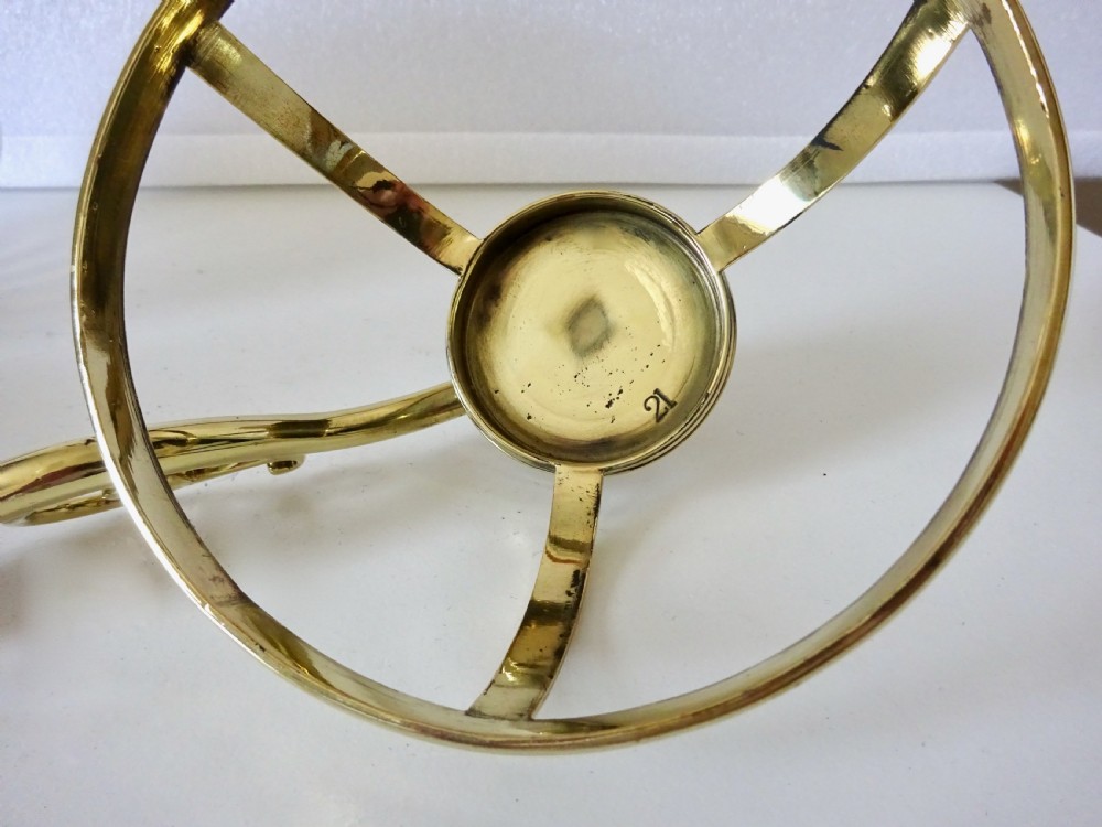 A Victorian brass wall-mounted oil lamp with a swirling blue glass reservoir held in a metal frame alongside a crimped blue glass shade. View VII