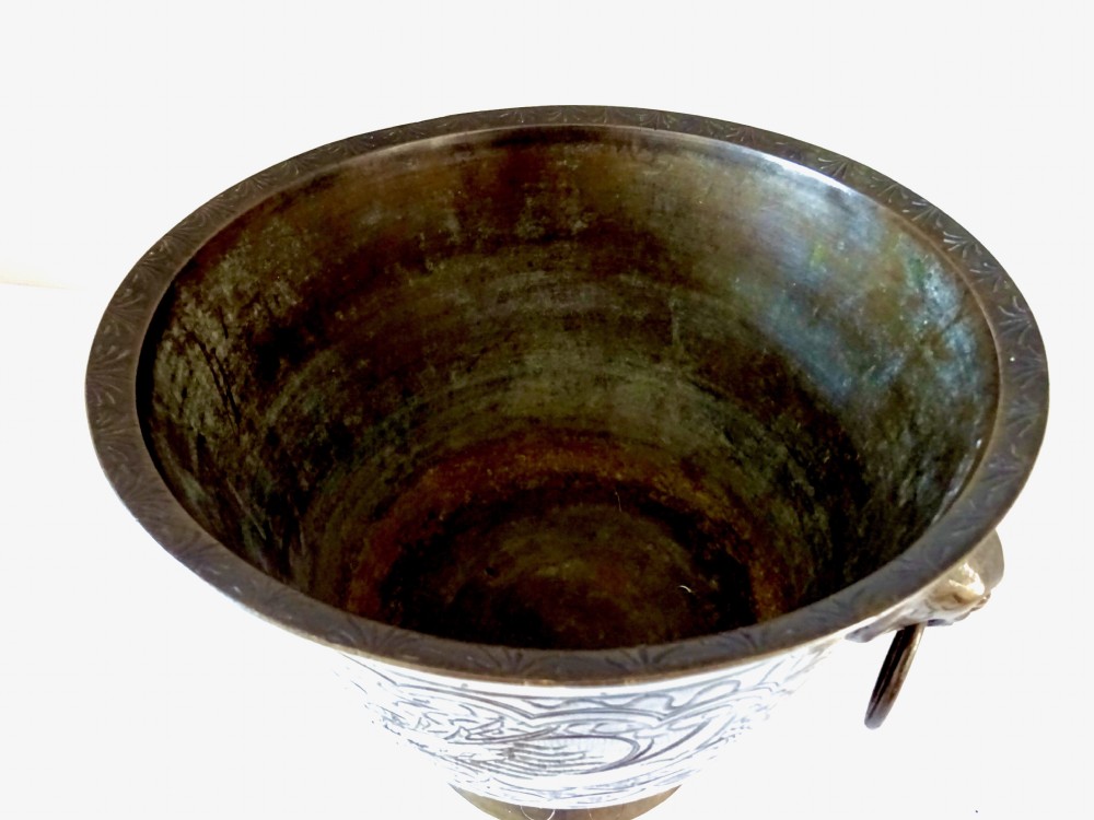 A deep flared dark bronze jardiniere featuring mask drop-ring handles and intricate engraved pattern band on a pedestal base. View III