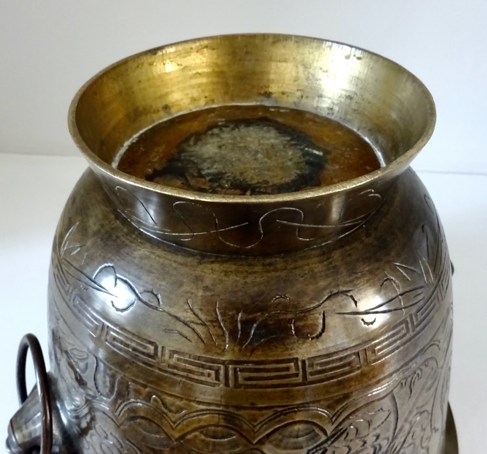 A deep flared dark bronze jardiniere featuring mask drop-ring handles and intricate engraved pattern band on a pedestal base. View IX