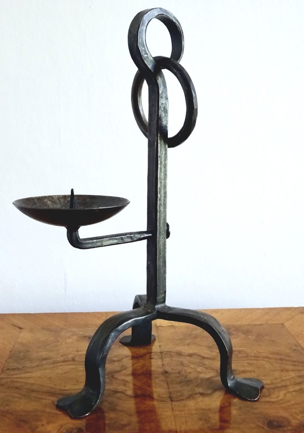 AN IRON CANDLE HOLDER