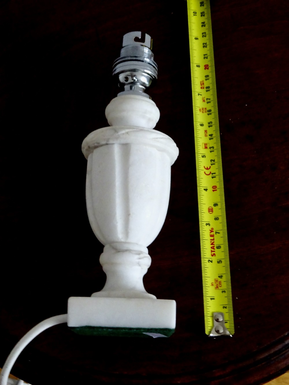 A small carved white marble table lamp base shaped like a classical urn resting on a square plinth. View IV