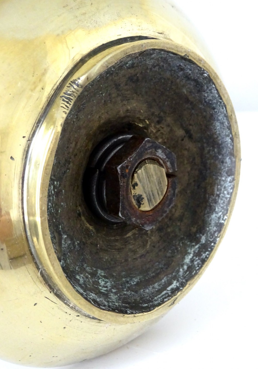 A polished brass chamberstick featuring an open barley twist stem set into a circular dish tray with a thumb ring handle. View VII