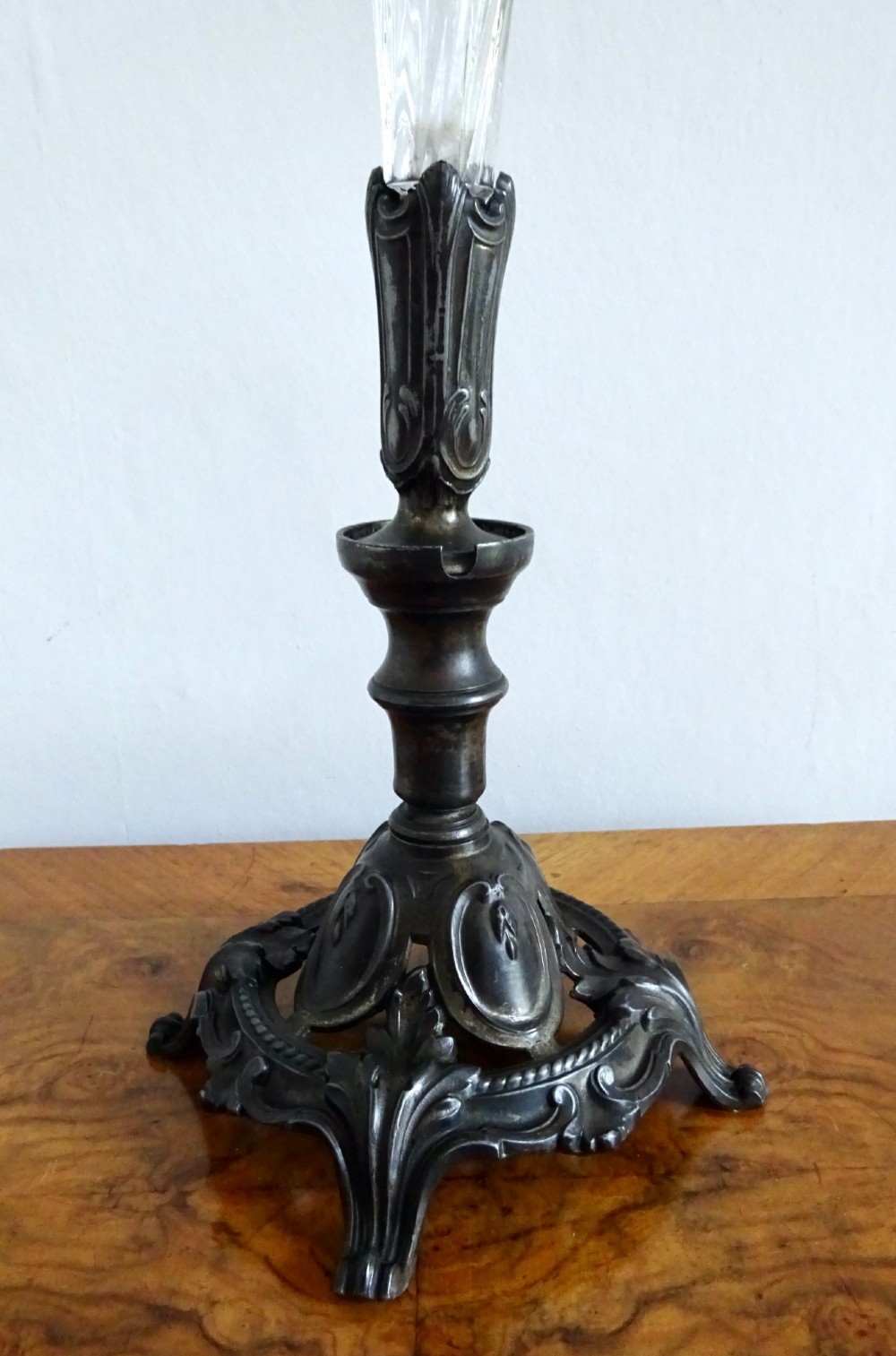 An antique single-trumpet epergne featuring a fluted clear glass vase fitted into an ornate dark cast-spelter base. View II