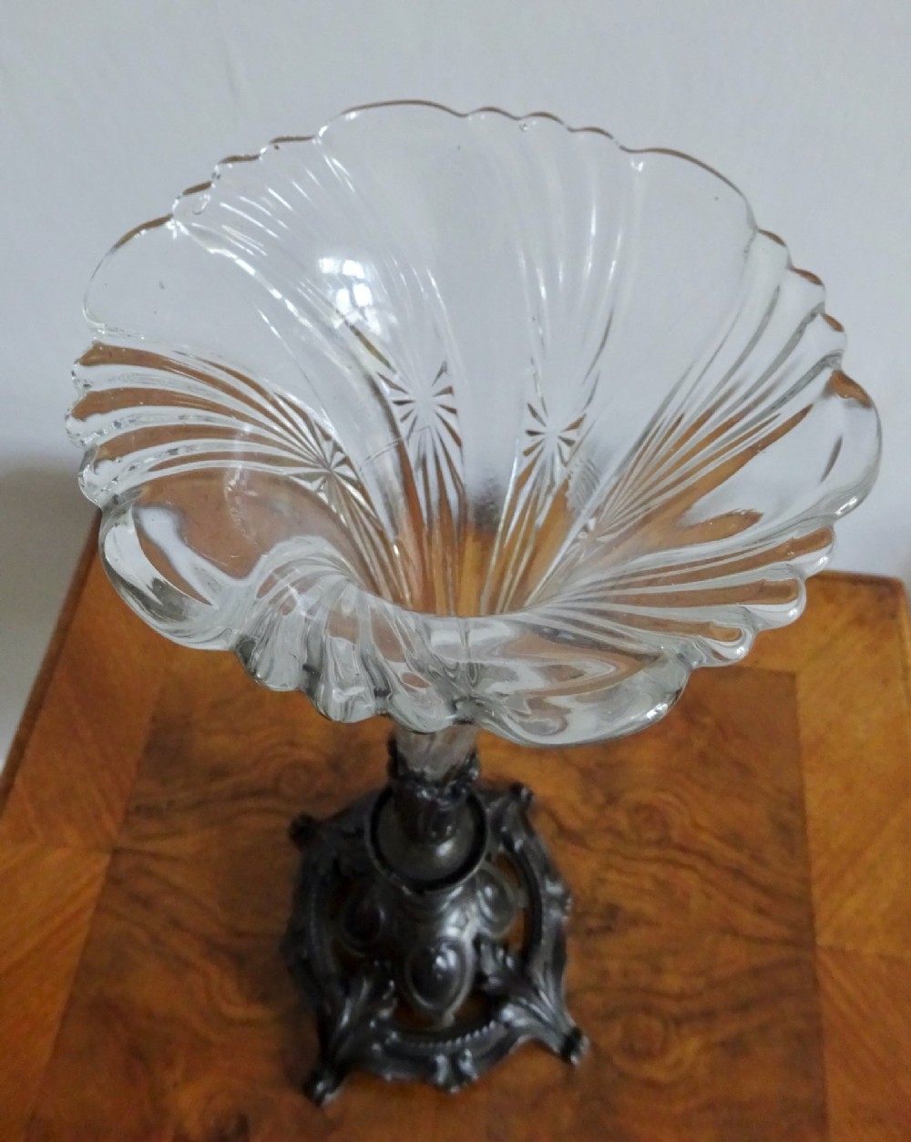 An antique single-trumpet epergne featuring a fluted clear glass vase fitted into an ornate dark cast-spelter base. View IV