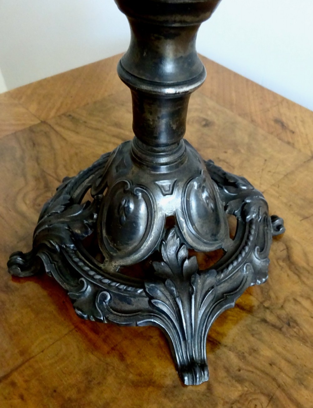 An antique single-trumpet epergne featuring a fluted clear glass vase fitted into an ornate dark cast-spelter base. View V
