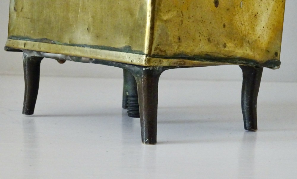 An antique brass oil lantern featuring a rectangular glass window, perforated ventilation top, turned wooden handle, and stamped manufacturer markings. View IX