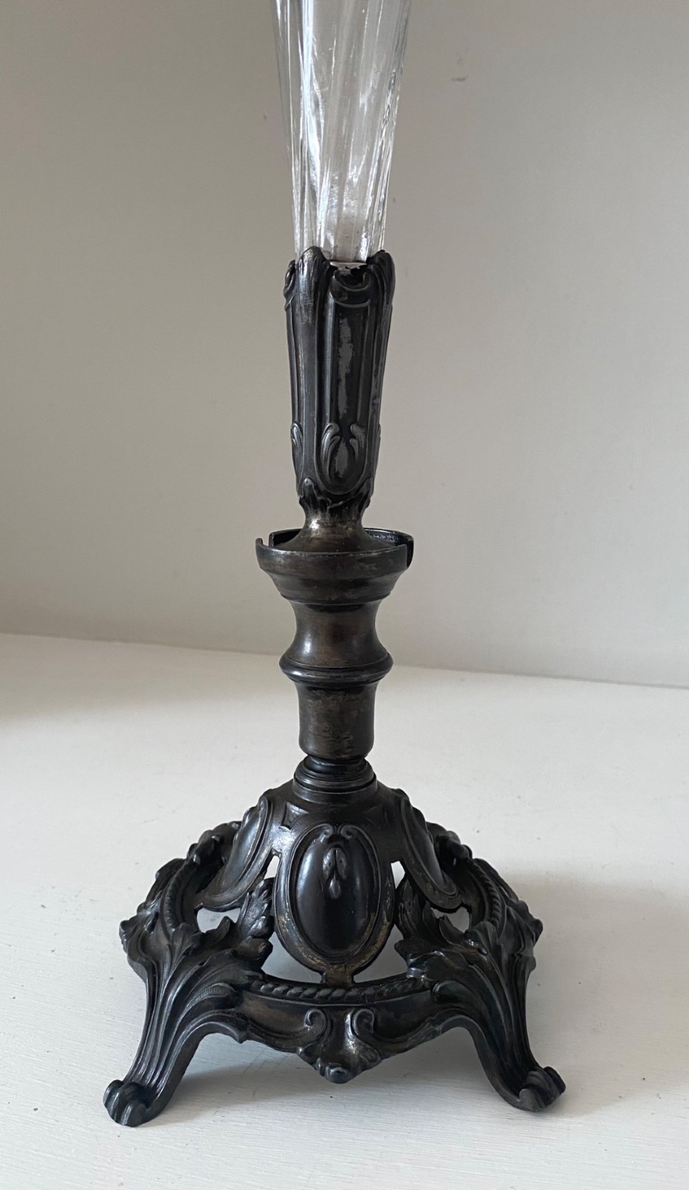 An antique single-trumpet epergne featuring a fluted clear glass vase fitted into an ornate dark cast-spelter base. View II