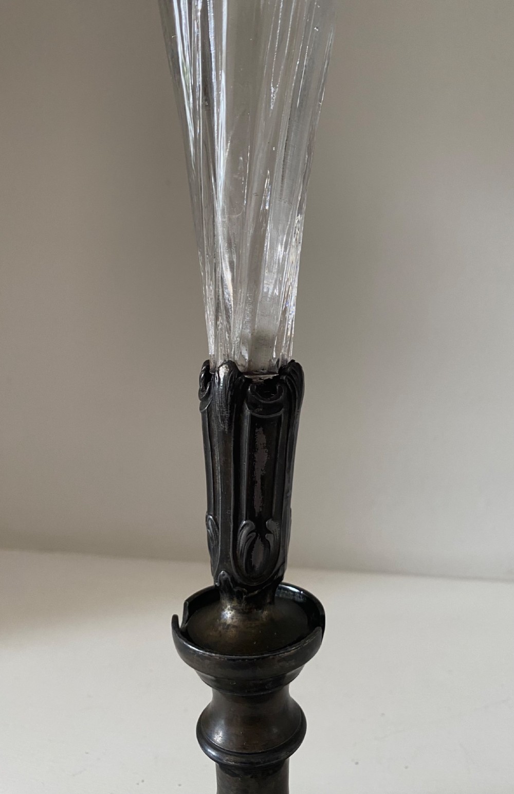 An antique single-trumpet epergne featuring a fluted clear glass vase fitted into an ornate dark cast-spelter base. View IV