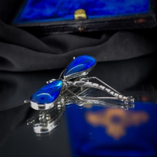 fig 3. An Art Deco sterling silver brooch designed in the shape of a dragonfly with iridescent blue butterfly wings set beneath glass.