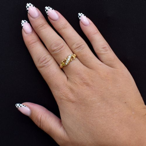 fig 1. An 18ct yellow gold ring set with five graduated old-cut diamonds across a carved scrollwork band.