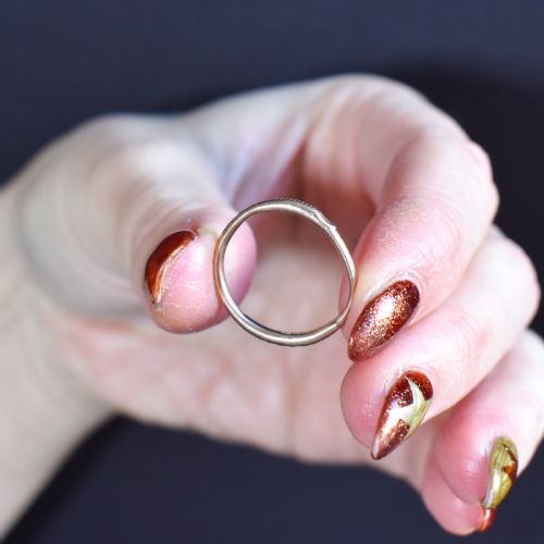 fig 1. A Georgian 9ct gold split ring with hand-engraved serpent Ouroboros details.