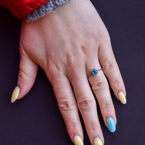 fig 2. A vintage 9ct gold solitaire ring featuring a brilliant round-cut blue zircon gemstone held in a multi-claw setting.