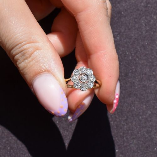 fig 1. An antique diamond cluster ring in a flower shape set in platinum with an 18ct yellow gold band.