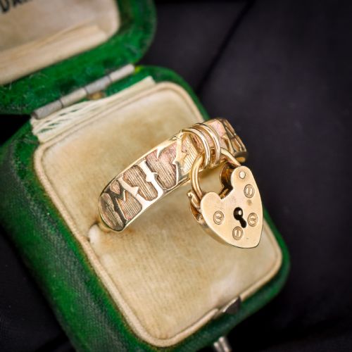 fig 1. A vintage 9ct yellow gold band ring featuring relief MIZPAH lettering and a dangling heart padlock charm.