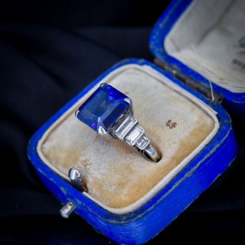 fig 2. An Art Deco sterling silver cocktail ring set with a large square-cut blue gemstone and stepped baguette-cut side stones.