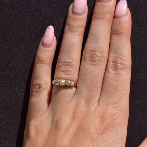 fig 2. An 18ct yellow gold Victorian five-stone ring featuring three round pearls alternating with two old-cut diamonds.