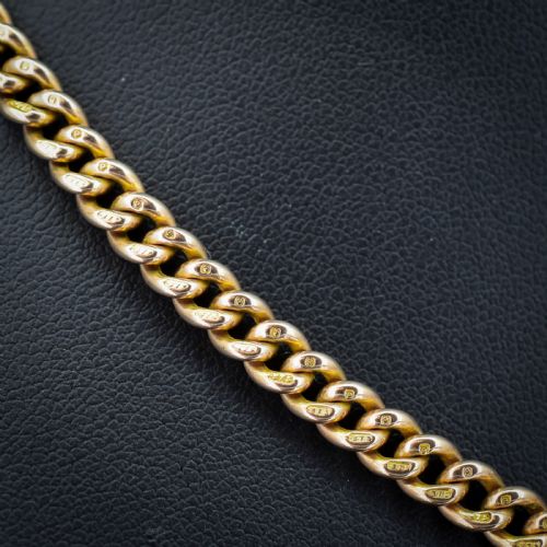 fig 2. A 9ct yellow gold uniform curb link Albert watch chain featuring a T-bar and dog clip fastings.