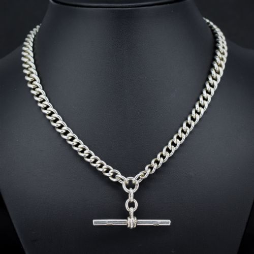 fig 1. An antique sterling silver heavy curb link Albert watch chain featuring a T-bar and swivel clasp, displayed flat.