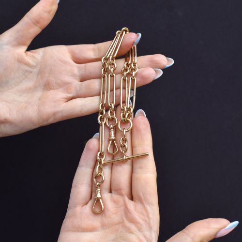 fig 1. An antique 9ct gold trombone link Albert chain necklace with a T-bar, dog clip, and bolt ring clasp.