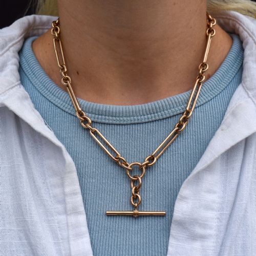 fig 2. An antique 9ct gold trombone link Albert chain necklace with a T-bar, dog clip, and bolt ring clasp.
