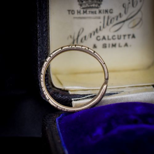 fig 1. An antique 9ct yellow gold split ring measuring 17mm with hand-engraved notch details around the outer circumference.