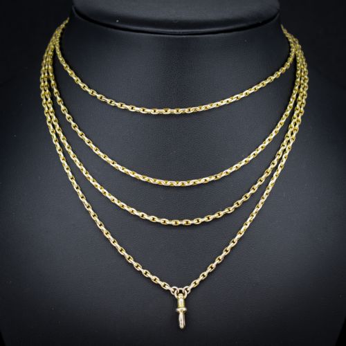 fig 1. A long 9ct yellow gold faceted link guard chain wrapped in loops beside a swivel dog clip clasp.