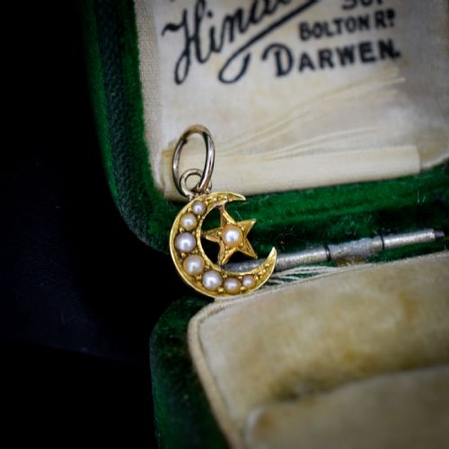 fig 1. An 18ct gold crescent moon pendant set with seed pearls enclosing a star motif.
