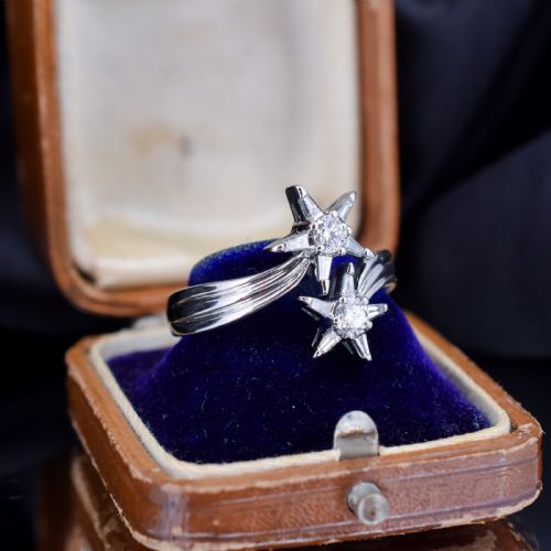 fig 1. An 18ct white gold bypass ring featuring two star motifs set with brilliant-cut and baguette diamonds.