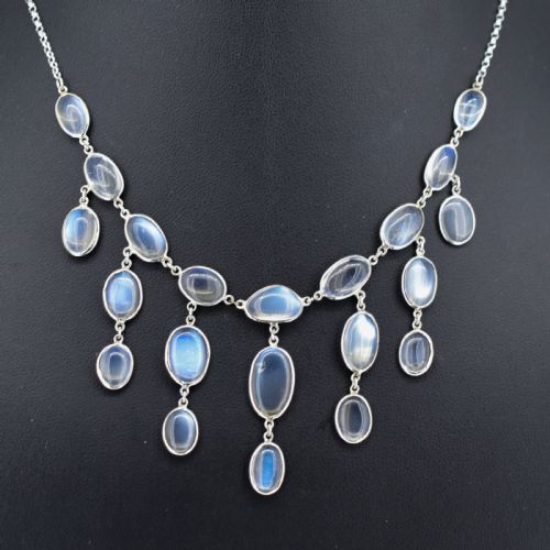 fig 2. An antique silver festoon necklace featuring tiered oval cabochon moonstone drops suspended from a central chain.