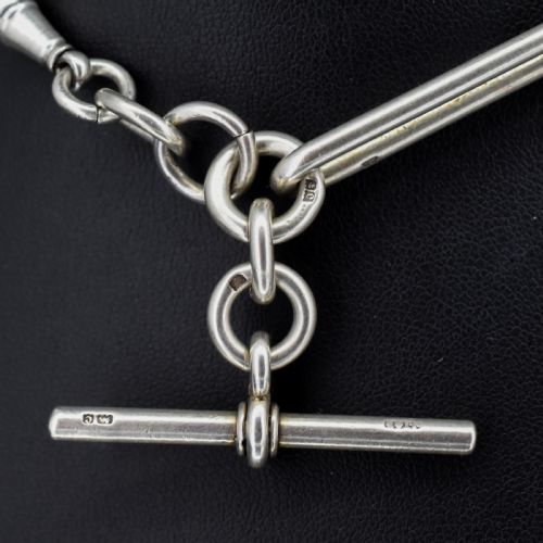fig 2. An antique sterling silver Albert watch chain featuring elongated trombone links interleaved with twisted love knots, complete with a T-bar and swivel clip.