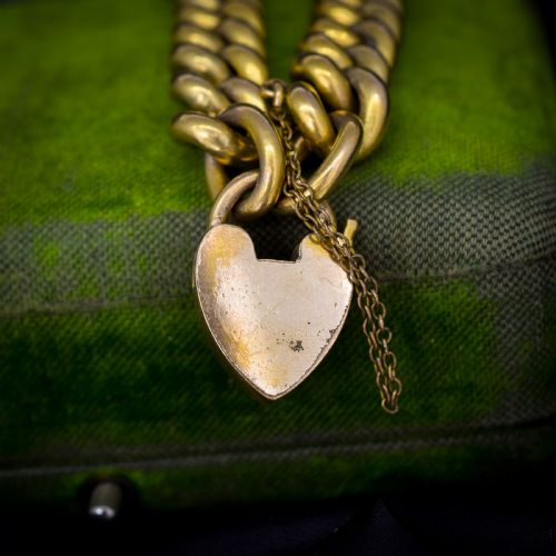fig 2. An antique rolled gold curb link bracelet featuring a heart-shaped padlock clasp and safety chain.