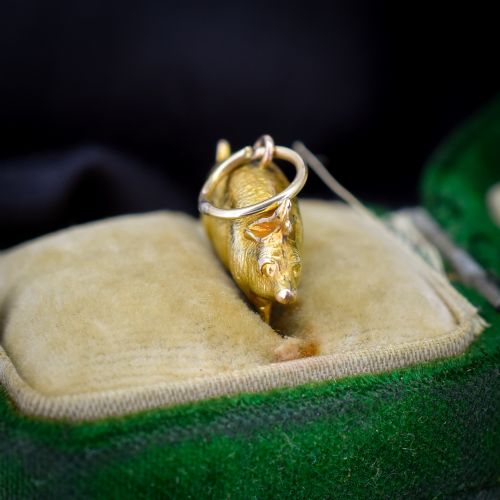 fig 1. An Edwardian 9ct yellow gold pig charm featuring a textured three-dimensional body and an attached suspension ring.