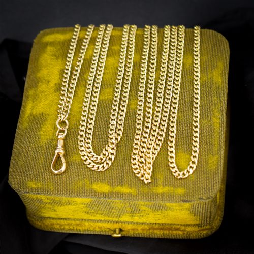 fig 2. An antique 9ct yellow gold curb link guard chain layered in multiple loops with a dog clip fastener on a black bust.
