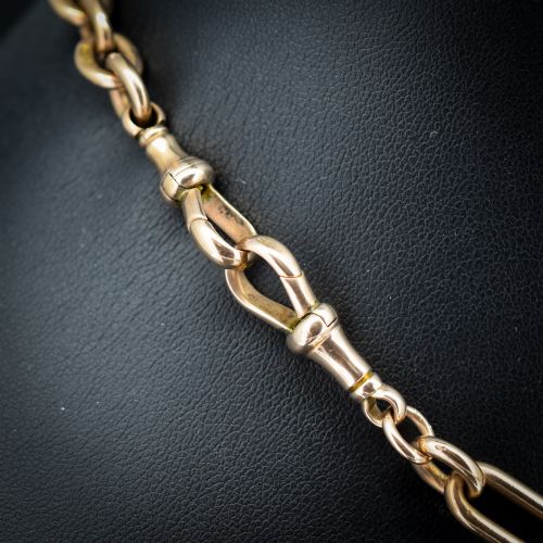 fig 2. An Edwardian 9ct gold trombone link chain necklace with a central T-bar drop and dog clip clasp.