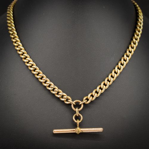 fig 1. An antique rolled gold curb link watch chain featuring a central T-bar dropper and double dog clip fasteners.