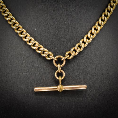 fig 2. An antique rolled gold curb link watch chain featuring a central T-bar dropper and double dog clip fasteners.