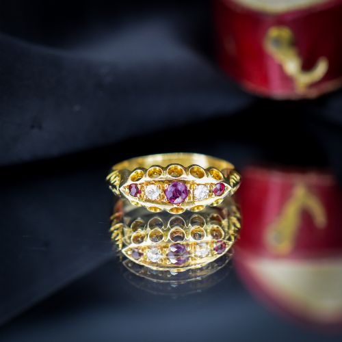 fig 2. An antique 18ct yellow gold boat ring set with three round rubies alternating with two diamonds across a carved gallery setting.