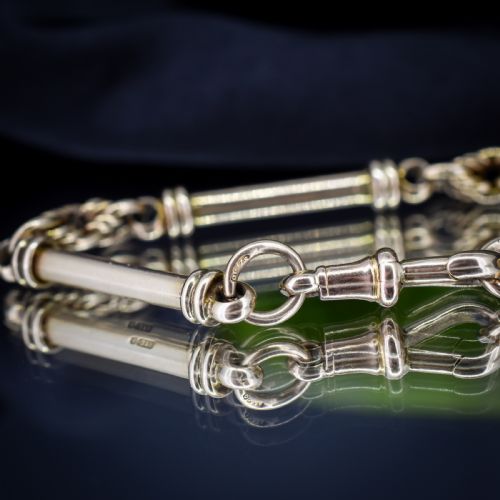 fig 2. An antique 9ct yellow gold bracelet featuring elongated tubular bar links interspersed with love knot connections and a dog clip clasp.