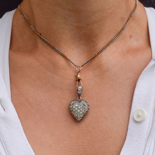 fig 1. A heart-shaped sterling silver pendant paved with hand-cut clear glass paste stones featuring an ornate bail.