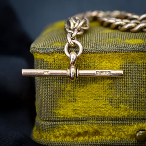 fig 1. An antique 9ct gold graduated curb link Albert watch chain featuring a central T-bar and twin swivel dog clips.