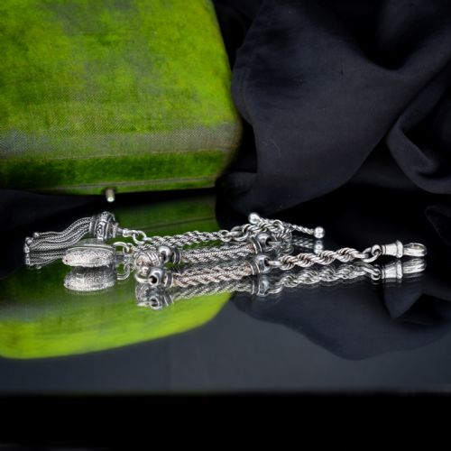 fig 1. An antique silver Albertina watch chain styled as a bracelet, featuring multi-strand rope chains, an engraved heart motif charm, a silver tassel, a T-bar, and a swivel clasp.