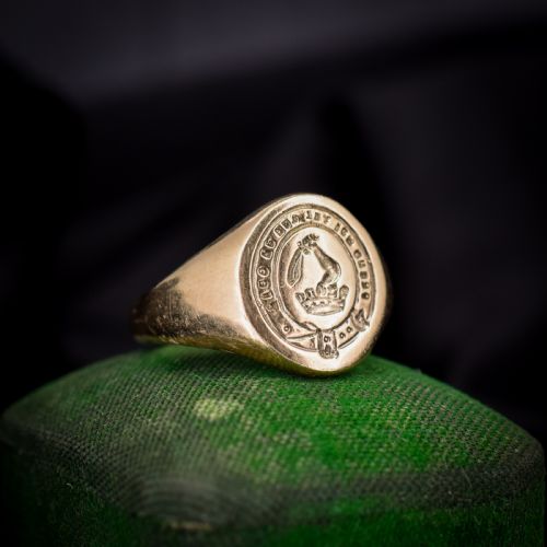 fig 1. A vintage 9ct yellow gold signet ring featuring an oval bezel hand-engraved with a crest intaglio design.