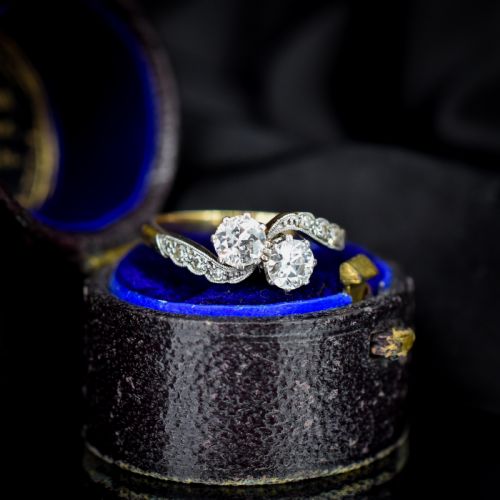 fig 1. An antique diamond Toi et Moi ring featuring two diamonds set in a platinum crossover mount on an eighteen carat gold band.