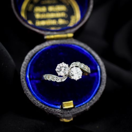 fig 2. An antique diamond Toi et Moi ring featuring two diamonds set in a platinum crossover mount on an eighteen carat gold band.