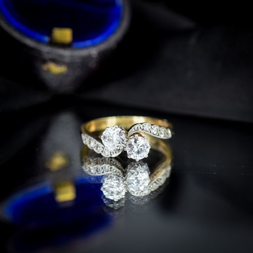 fig 3. An antique diamond Toi et Moi ring featuring two diamonds set in a platinum crossover mount on an eighteen carat gold band.
