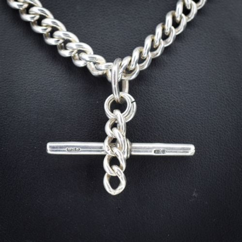 fig 1. A sterling silver uniform curb link necklace with a T-bar pendant and dog clip clasp displayed on a black neck bust.