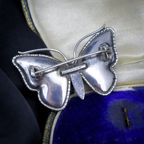 fig 3. An Art Deco sterling silver butterfly brooch featuring vibrant iridescent blue butterfly wing panels beneath glass.