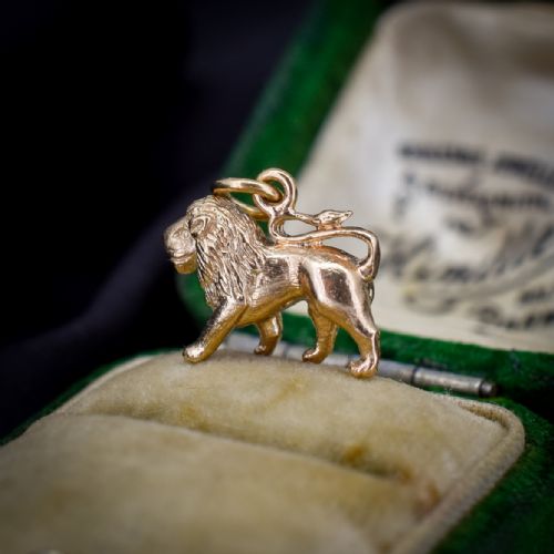 fig 1. A small 9ct yellow gold charm sculpted in the shape of a standing lion with a textured mane.