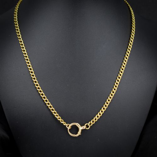 fig 1. An antique 18ct yellow gold curb link chain necklace featuring a circular bolt ring clasp on a green velvet surface.